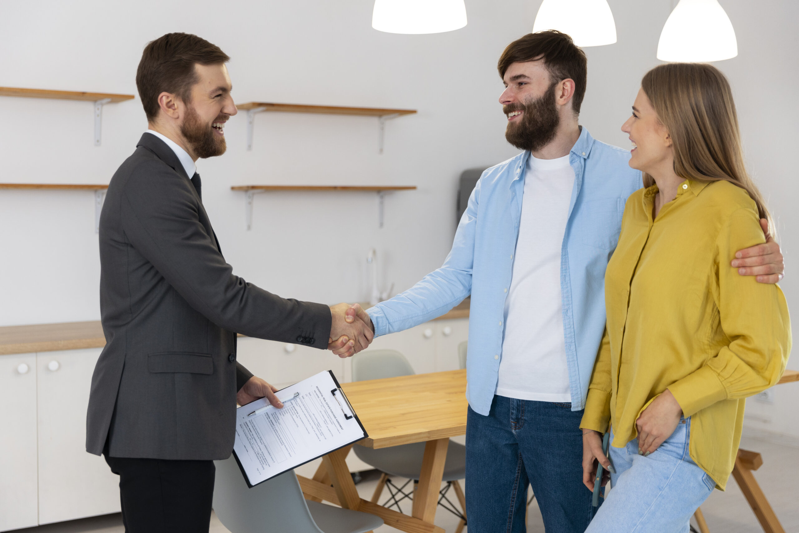 Male Real Estate Agent Doing Business Showing House Potential Buying Couple
